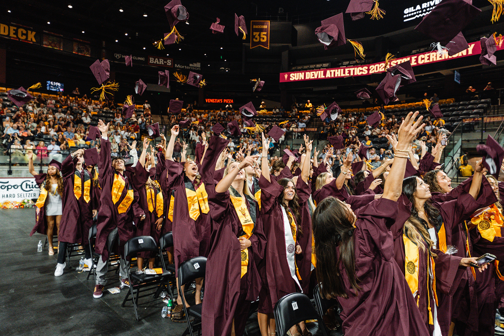 Graduates throwing their caps in the air.